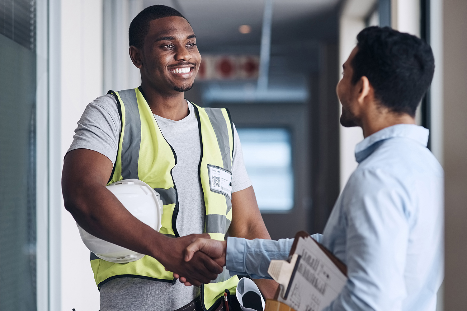 two male workers shaking hands