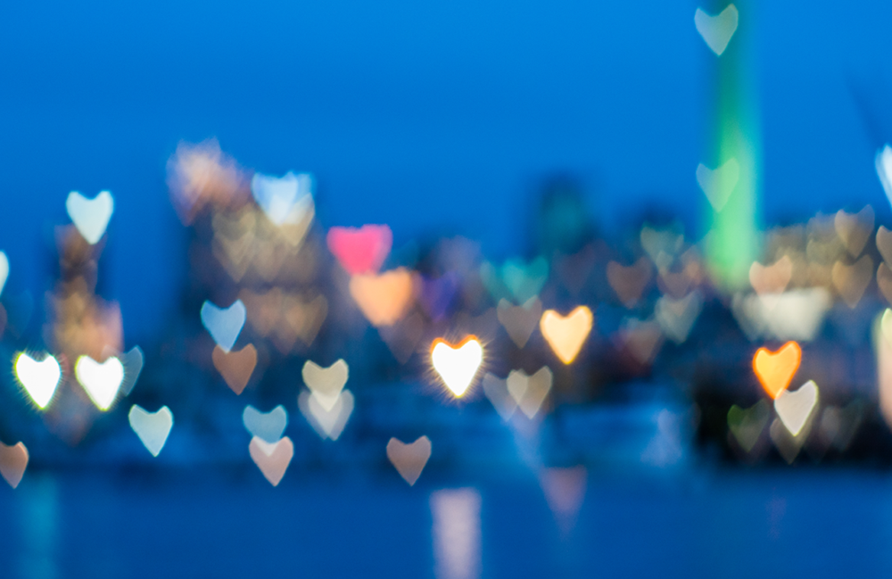 city skyline with blurred heart-shaped lights