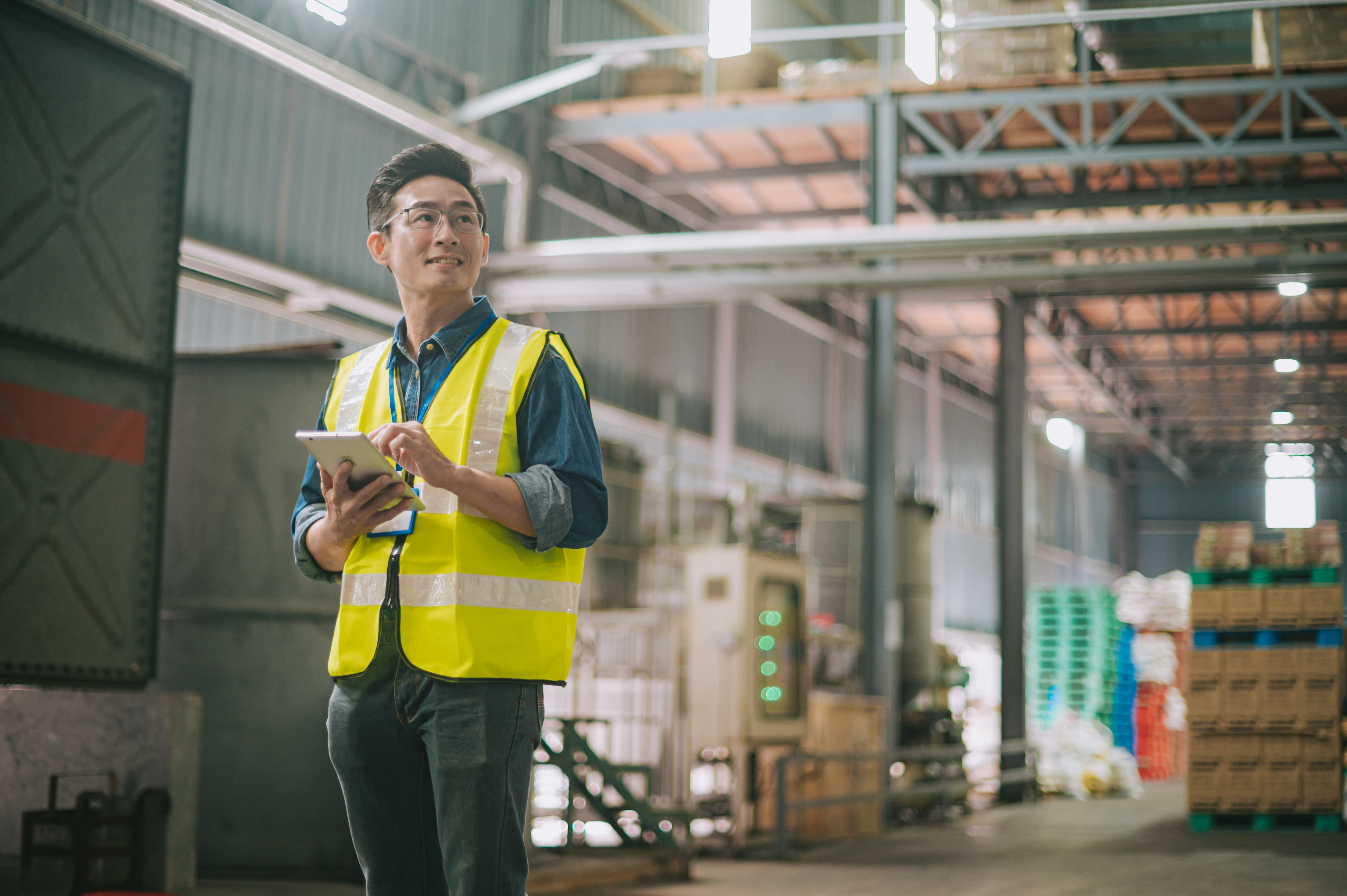 Man in safety vest in industrial building