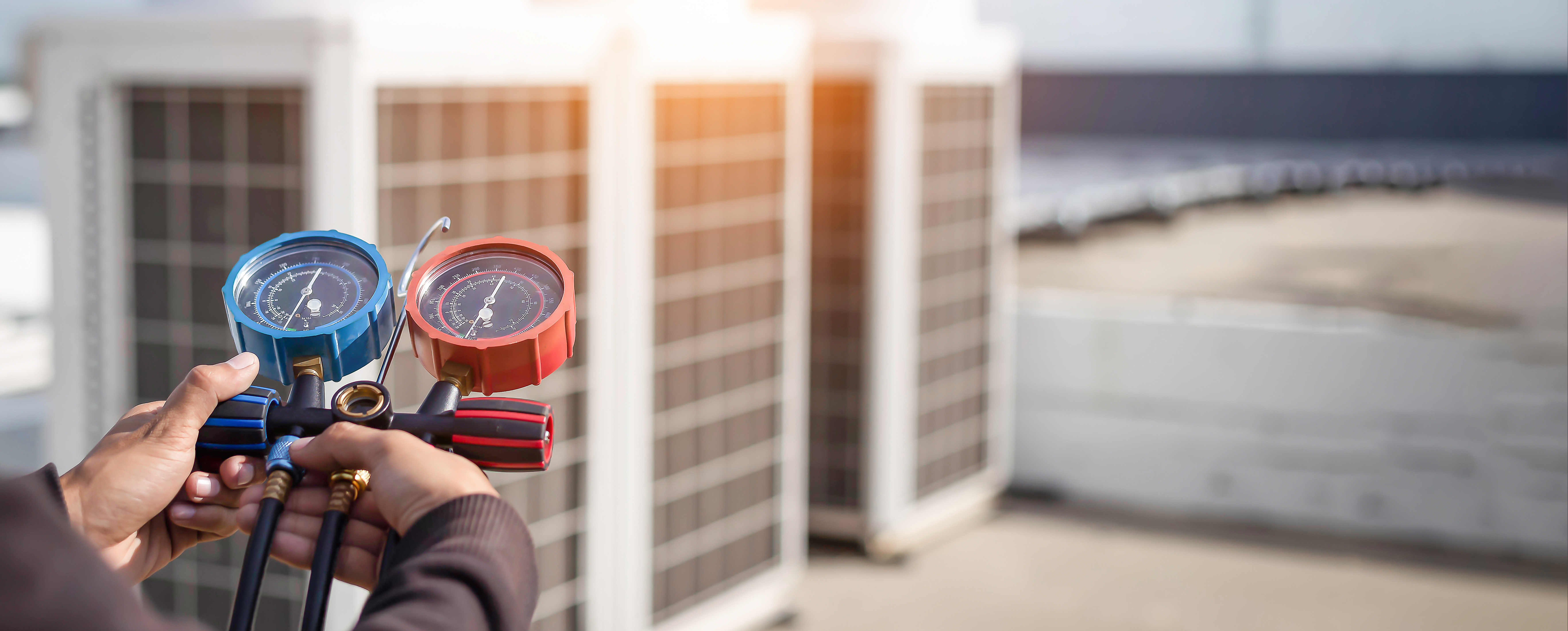 HVAC gauge in front of commercial HVAC system