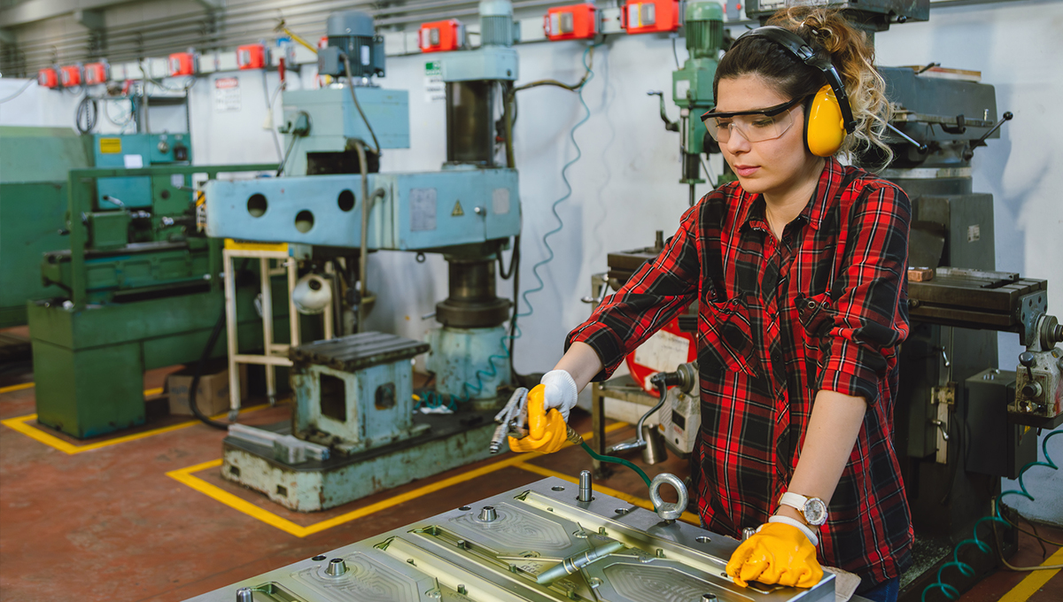 A worker using compressed air in an industrial setting
