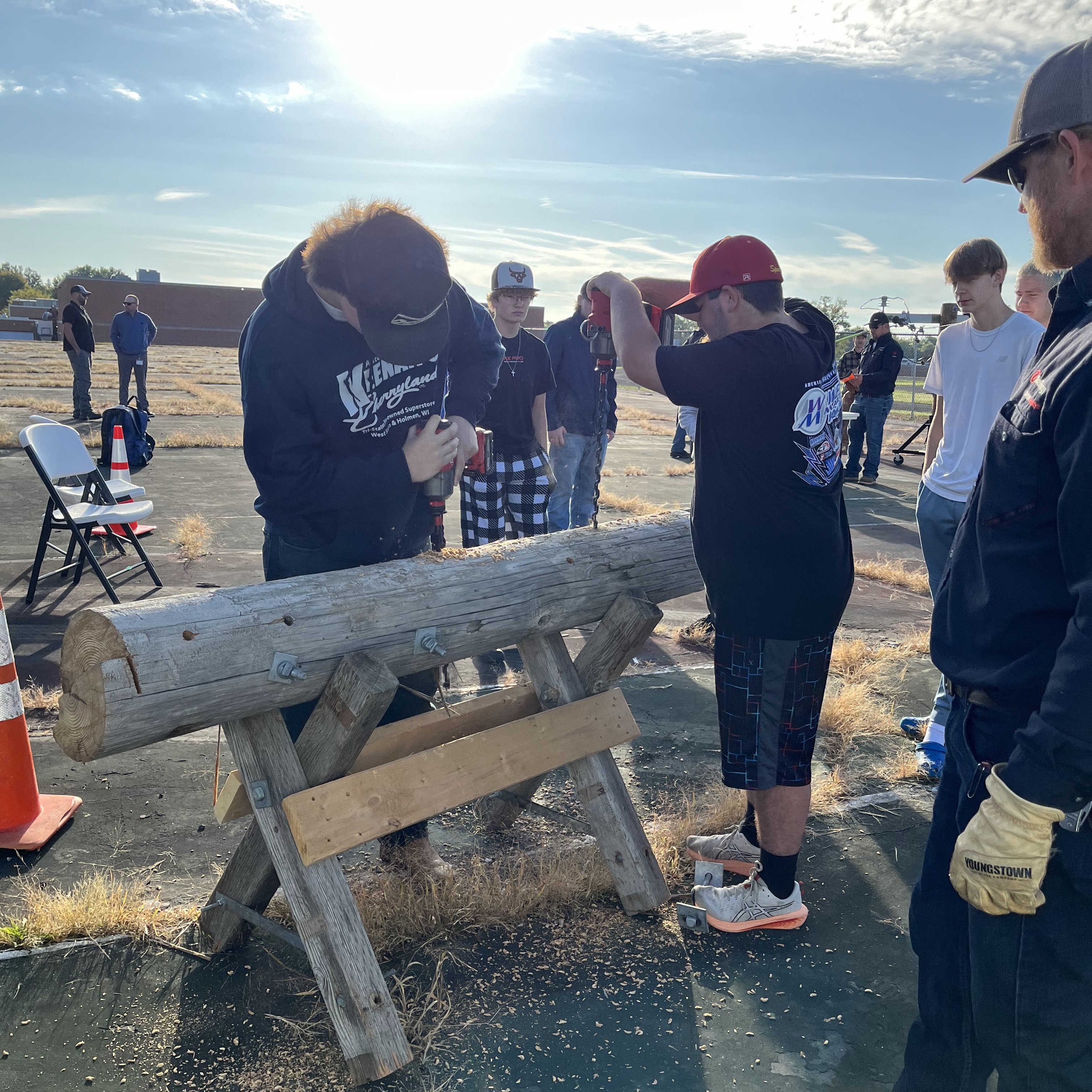 Students observing how power line poles are created