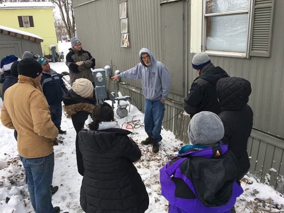 Residents look under mobile home