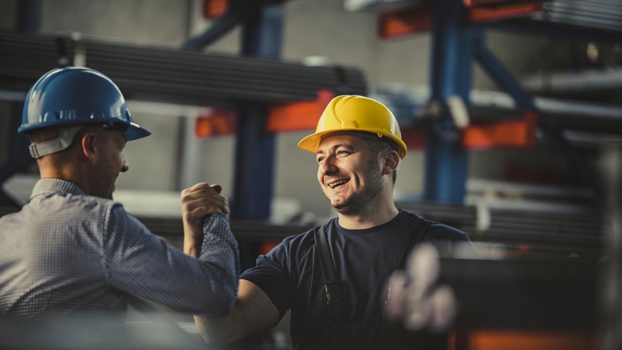 workers in hard hats giving a high five