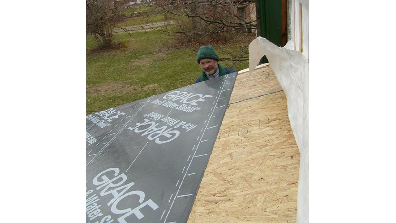 man looking at roof being constructed