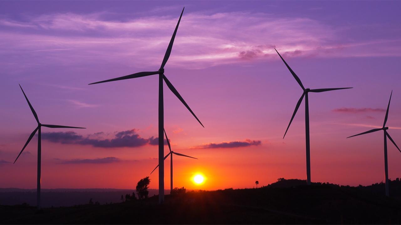 Wind turbines in front of a sunrise
