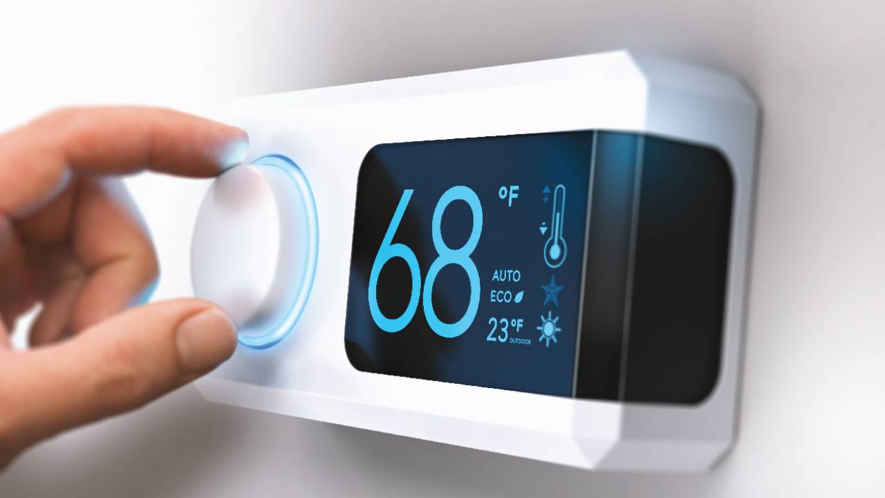 hand adjusting smart thermostat