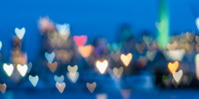 city skyline with blurred heart-shaped lights
